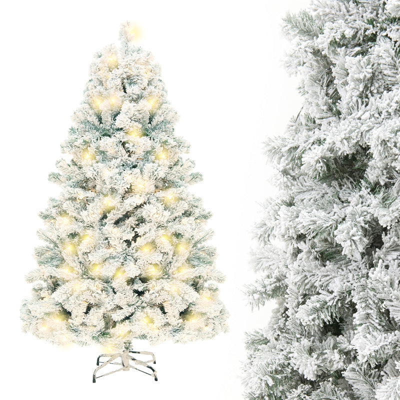 Snow-flocked white Christmas tree with warm-white lights