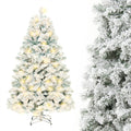Snow-flocked white Christmas tree with warm-white lights
