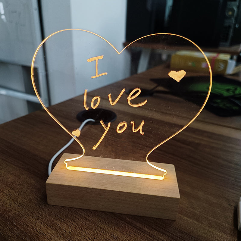 Glowing acrylic message board lamp on wooden base